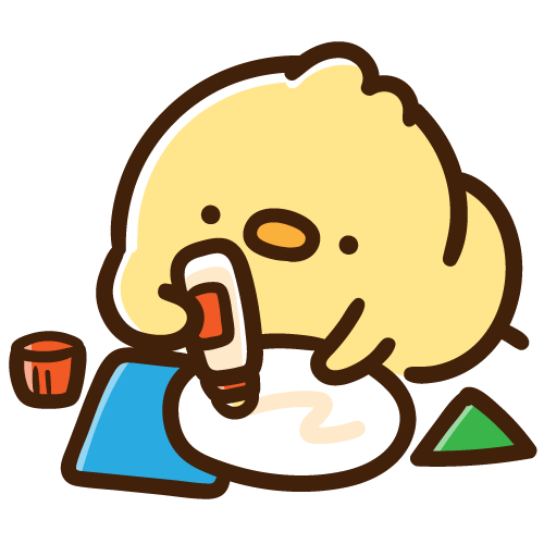 紙に糊を塗って何かを作っているひよこ